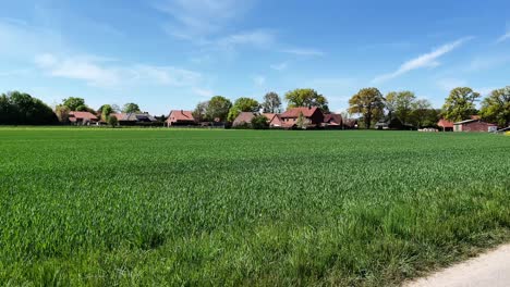 Rural-idyll-in-Lower-Saxony-Germany-countryside-with-green-lush-meadows,-trees-and-farms-on-a-sunny-spring-day