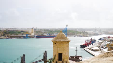 Industrial-vessels-of-cargo-harbor-in-Malta-island-with-cranes,-distance-view
