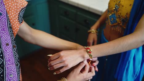 Middle-eastern-women-helping-each-other-to-put-on-jewelery