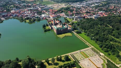 Scenic-View-Over-Frederiksborg-Castle-And-Surroundings-In-Hillerod,-Denmark---aerial-drone-shot