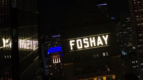 Cinematic-aerial,-Foshay-Tower-in-downtown-Minneapolis-at-night