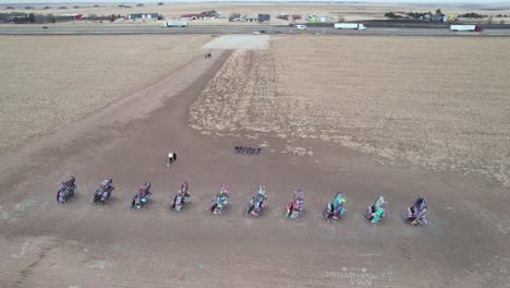 Aerial-View-of-Cadillac-Ranch,-Colorful-Art-Installation-by-Historic-Route-66-Near-Amarillo,-Texas-USA,-Drone-Shot
