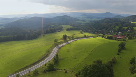Cars-driving-on-new-countryside-highway-leading-to-czech-village