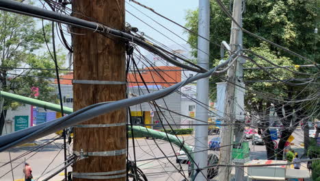 Nahaufnahme-Von-Stromleitungen,-Die-Die-Straße-Mit-Vorbeifahrendem-Verkehr-In-Mexiko-Stadt-Kreuzen
