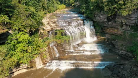 Cummins-Falls-Flowing-Into-The-River-With-Verdant-Forest-In-Tennessee,-Nashville