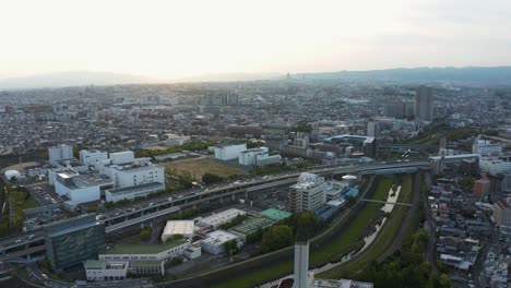 Osaka-Urban-landscape-of-Kadoma-at-sunset,-wide-aerial-panoramic-view