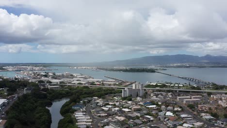 Super-wide-aerial-shot-of-Pearl-Harbor-with-the-USS-Arizona-Memorial-in-the-background-on-the-island-of-O'ahu,-Hawaii