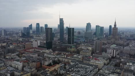 Aerial-view-towards-the-Warsaw-city-skyline,-gloomy-day-in-Poland---approaching,-drone-shot