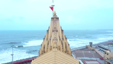Aerial-shot-of-Somnath-mandir-with-Arabian-sea-in-the-background-in-the-sunny-weather