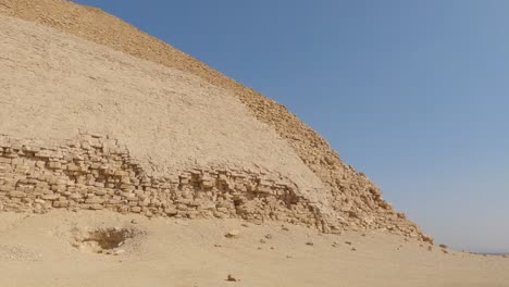 Panning-Over-Sandy-Desert-To-Ancient-Egyptian-Bent-Pyramid-On-Sunny-Day,-Egypt