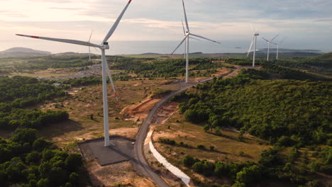 New-built-wind-turbines-on-majestic-coastline-of-Vietnam,-aerial-view