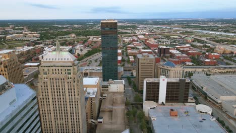 Aerial-view-overlooking-streets-in-middle-of-highrise-in-Oklahoma-city,-USA---tilt,-drone-shot