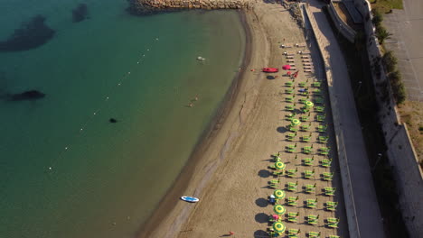 Tropical-sand-summer-sea-beach-with-umbrellas-and-chairs-aerial-view
