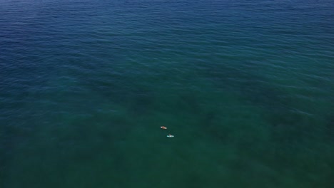 Two-People-Kayaking-In-Calm-Blue-Sea-On-A-Sunny-Day-In-Costa-Del-Sol,-Estepona,-Spain