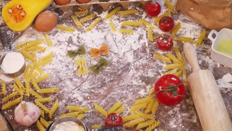 Hand-Arranging-Pasta,-Tomato-and-Onion-in-a-well-ordered-fashion-on-a-table