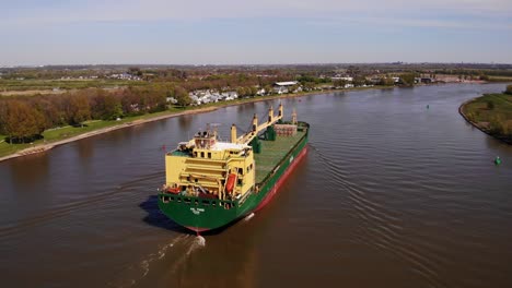 Aerial-Circle-Dolly-Around-Stern-Of-Aal-Paris-Cargo-Ship-Travelling-Along-Oude-Maas-On-Sunny-Clear-Day