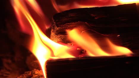 Close-up-of-flaming-logs-in-wood-burning-stove