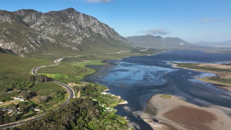 Elevated-aerial-view-over-Klein-River-Lagoon-next-to-scenic-mountains,-Hermanus