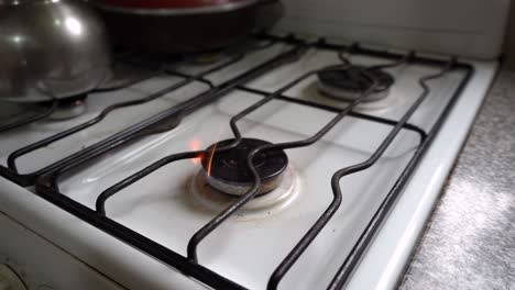 Burner-Gas-Stove-Is-Lit-By-A-Woman's-Hand-With-A-Lighter