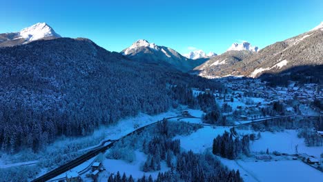 Wide-drone-Aerial-view-of-a-valley-in-the-mountains-with-snow-in-winter