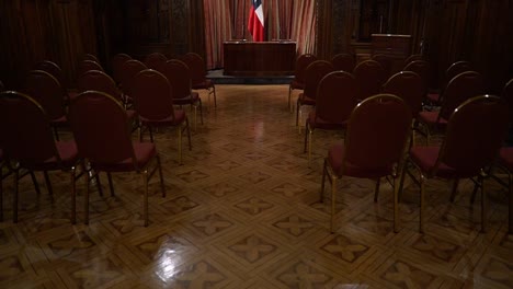 Tilt-up-of-the-conference-room-of-the-Bruna-Palace,-current-headquarters-of-the-National-Chamber-of-Commerce,-Services-and-Tourism-of-Chile,-Chilean-flag