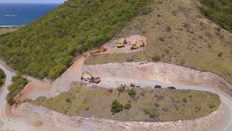 Aerial-view-of-excavators-building-holiday-homes-and-hotels,-on-a-Caribbean-paradise-island---tilt,-drone-shot
