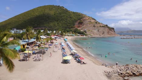 Aerial-view-in-front-of-people-on-the-Frigate-Bay-beach-in-Saint-Kitts-and-Nevis--tracking,-drone-shot