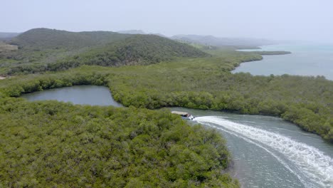 Sightseeing-by-boat-along-banks-of-coastal-lagoons-surrounded-by-mangrove-forest-in-Monte-Cristi-National-Park-in-Dominican-Republic