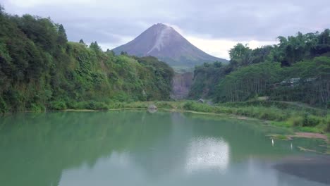 Blue-lake-surface-with-Mount-Merapi-in-the-background