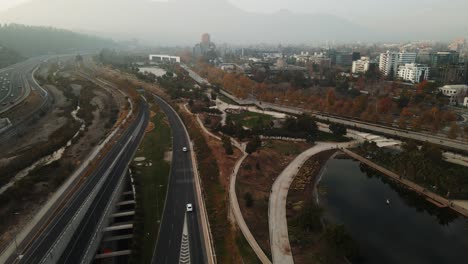 Aerial-view-of-a-chilean-road-with-some-cars-passing-by-near-Bicentenario-park