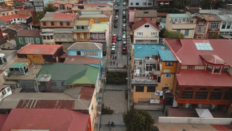Aerial-dolly-in-of-picturesque-colorful-houses-going-uphill-Cerro-Alegre-in-Valparaiso-World-Heritage-Site-city,-Chile