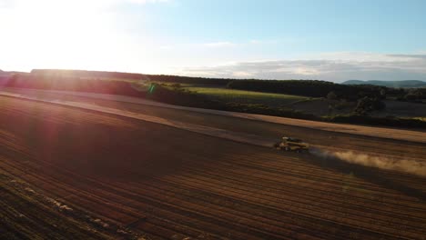 Aerial-of-a-combine-harvesting-wheat-during-sunrise