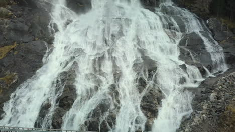 Close-Up-View-of-the-Famous-Furebergfossen-Waterfall-in-Norway,-Sliding-Drone-Shot