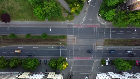 Bicyclists-are-followed-cars-drive-pedestrians-walk-Calmer-aerial-view-flight-drone-camera-pointing-down-footage
of-Berlin-Prenzlauer-Berg-Allee-Summer-2022