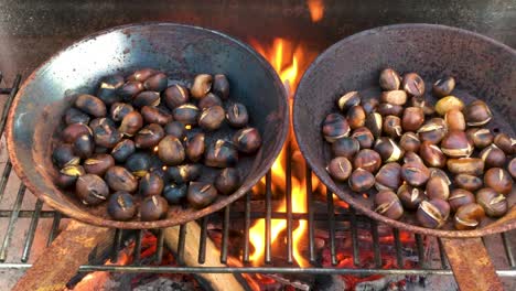 Chestnuts-roasted-on-open-fire,-seasonal-delicacy,-harvest,-4k-UHD,-pan-left-to-right