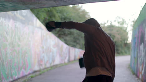 Medium-Shot-of-Young-Active-Man-Boxing-In-Underpass,-Silhouetted-By-Light