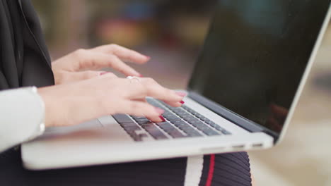 Close-Up-Shot-Of-Woman-Typing-On-Keyboard-Whilst-Working-Outside-,-In-Slowmotion