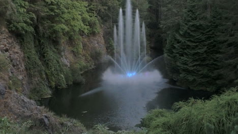 A-pan-tilt-shot-reveals-multiple-streams-spouting-from-a-lake-as-a-lighted-fountain