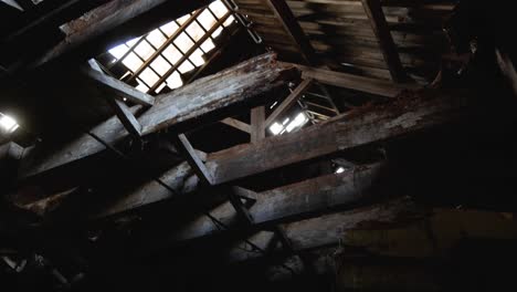 Creepy-shot-of-the-exposed-roof-beams-in-an-abandoned-barn
