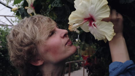 Girl-smelling-a-Hibiscus-flower-closeup-view
