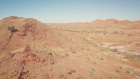 Aerial-Drone-flying-along-mountain-ridge-in-vast-Australian-Desert