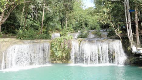 Water-flowing-from-Cambugahay-Falls-into-natural-turquoise-pool-in-Siquijor-Island,-the-Philippines-in-ultra-slow-motion-on-tripod