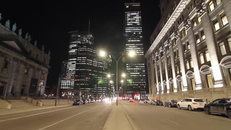 Cinematic-street-time-lapse-of-cars-driving-downtown-at-night
