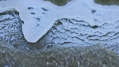 Seaside-icy-waves-in-winter-morning-light