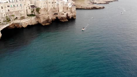Drone-reveals-Polignano-cliff-with-a-vertical-pan-movement