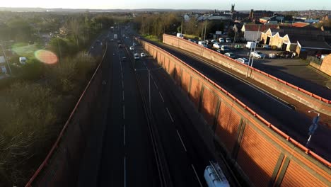 Panning-view-of-traffic-on-the-A50-road-to-Uttoxeter,-drivers,-commuters-and-logistical-lorries-travel-up-and-down-one-of-the-busiest-roads-in-the-city-of-Stoke-on-Trent