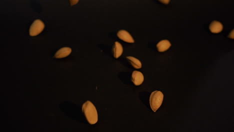 Almonds-falling-on-black-surface-slow-motion-100fps-Sony-S-Log2