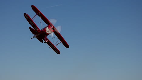 Aerobatic-Pitts-S2B-biplane-performs-a-turn-away-from-the-camera-during-a-low-pass