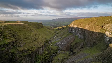 Time-lapse-footage-as-the-light-fades-looking-down-Mousegill-Beck-with-the-Eden-Valley-and-the-North-Pennines-in-the-background,-Cumbria-UK