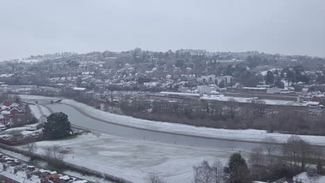 Sideways-tracking-drone-shot-of-snowy-Exeter-over-the-River-Exe-CROP
